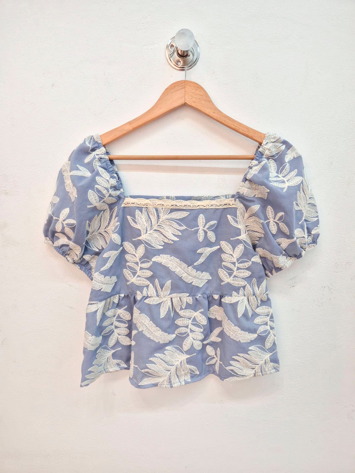 Blusa azul con estampado floral beige y mangas abullonadas cortas