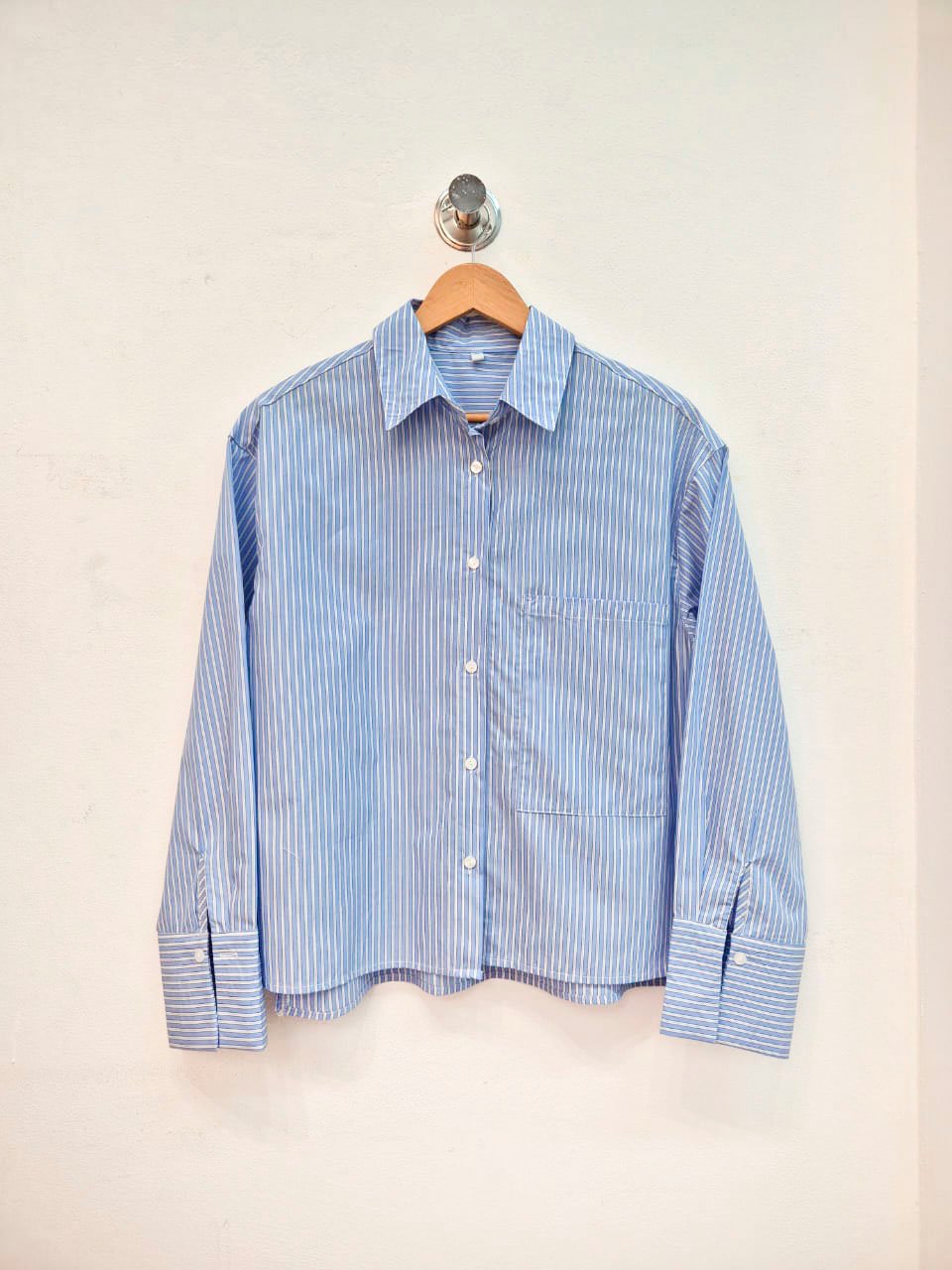 Camisa azul con rayas blancas, cuello clásico y manga larga